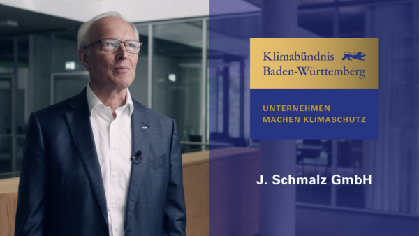 Klimabündnis Baden-Württemberg – J. Schmalz GmbH Rechts das Logo in gold und blau "Klimabündnis Baden-Württemberg, Unternehmen machen Klimaschutz" und die Aufschrift J. Schmalz GmbH. Links Herr Kurt Schmalz.