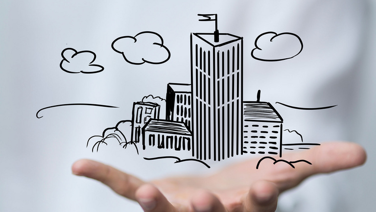 Über einer Handfläche schwebt unterschiedliche gezeichnete Häuser.